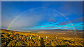NJ4124 : Rainbow on the way down the hill by Ralph Greig