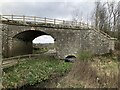 Bridge carrying former Border Counties Railway over minor road and stream