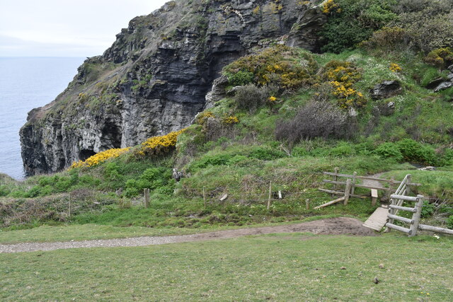 Path and footbridge above cliff waterfall