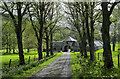 Estate road descending towards farm buildings