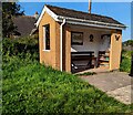 Bench and books in a bus shelter, Groesffordd, Powys