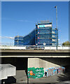 TQ4780 : New Building, Graffiti and Roadway by Des Blenkinsopp
