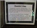 Framed  Thankful  Village  notice  in  St  Peters  Church