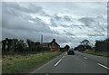 House and bus stops on the A38, heading south-west