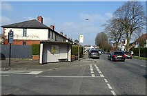SJ6699 : Bus stop and shelter on Warrington Road (A574) by JThomas