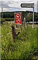 Direction sign 1 mile from Pen-y-Clawdd, 6 from Llansoy