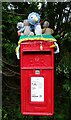 Close up, yarn bombed Elizabeth II postbox on Canal Road, Congleton