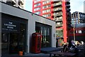 View of a red telephone box in front of The Lockdown Room bar on City Island