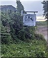 Holstein on a farm name sign in rural Monmouthshire