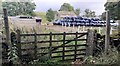 Footpath passing through field with silage bales at East End Farm