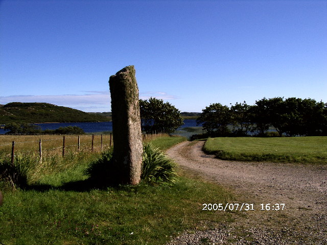 Standing Stone in grounds of Achaban House, Fionnphort, with Loch Poit na h-I (Loch Pottie) in background.