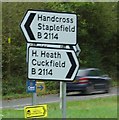 Road sign at Slough Green Junction showing destinations along Cuckfield Road.