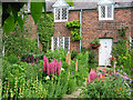 SJ3661 : Cottage and garden, Dodleston by Devon Rex