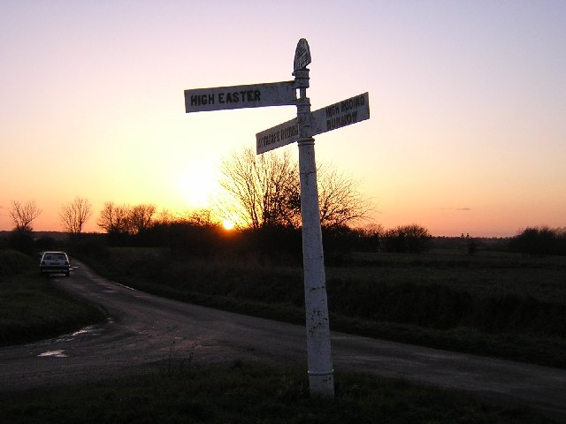 Cast iron signpost by sunset.