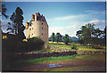 Pitfichie Castle with a distant Bennachie.