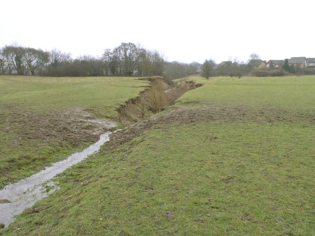 A brook cuts into a field near Borough Green