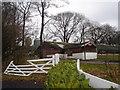 Farm buildings behind Doorway to Value furniture store