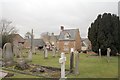 SK8402 : Houses and cemetery at Ridlington by Terry Butcher