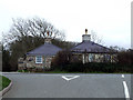 Lodge at estate entrance  beside a road junction