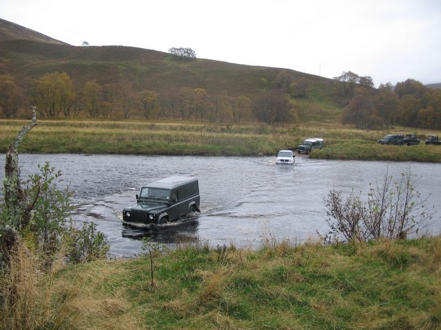 Grouse Beaters cross a ford on the River  Findhorn.