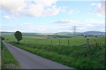 NJ4856 : Balnamoonhill Farm can be seen to the left of the Pylon. by Des Colhoun