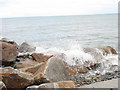 Moderate Sea Waves Breaking Against the Sea Defences