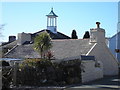 Lon Singrig: 18th century cottage, with art-deco design of Moreia chapel in background