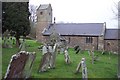 Wolvesnewton parish church with cross in the churchyard