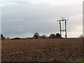 Ploughed fields and pylons near Treble Sykes Farm.