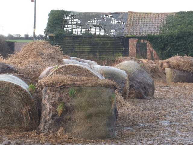 Derelict barn and old bales, west of Wicken