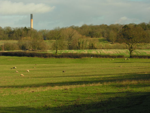 View across fields with unidentified chimney in distance