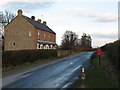 Cottages and postbox by country lane.