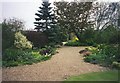 Gravel path winding through Denmans Garden, Fontwell