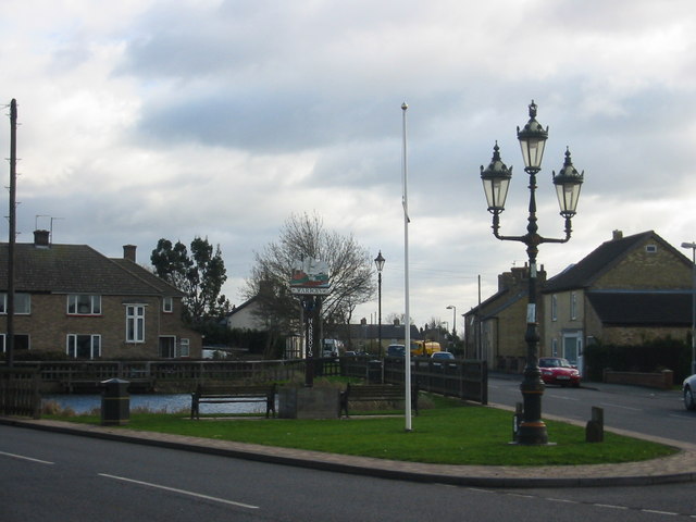 Pond, sign, flagpost and fancy streetlamp