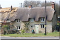 Thatched cottage being partly re-thatched