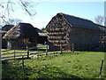 Typical thatched outbuilding and haystack