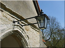 TL9211 : Memorial lamp outside Tolleshunt D'Arcy Church by William Metcalfe