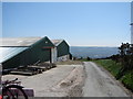 Looking downhill past some farm buildings near Eglwysllan Common