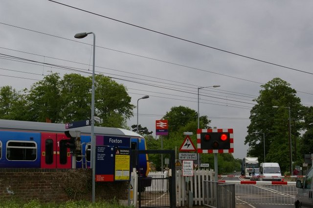 Level crossing at Foxton, with First Capital Connect train leaving station