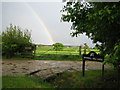 Rainbow and farm road near Sandhill