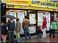 Newsagents Window opposite East Ham Station.