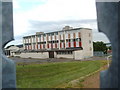 School, seen through a metal fence