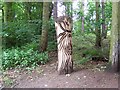 Wooden sculpture by footpath