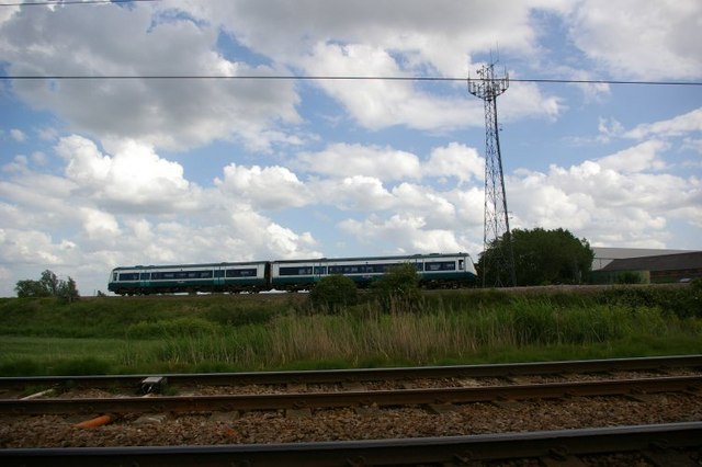 Train, railway track, and communications mast