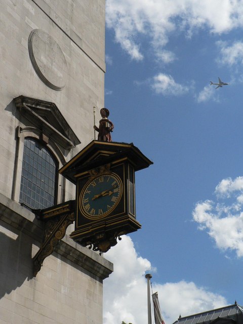 City of London: plane passes St. James Garlickhythe clock