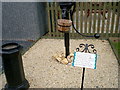 Old water pump handle and chimney pot  displayed in The Secret Garden, Eden Villa Park