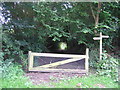 Gate, signpost and footpath.