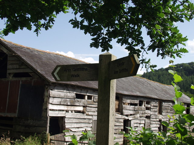 Timber barn and sign at Plas Dolanog