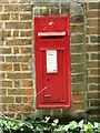 GR postbox set into wall of Bure River Cottage