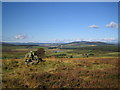 NO7190 : Cairn on Garrol Hill - looking west by Nigel Corby
